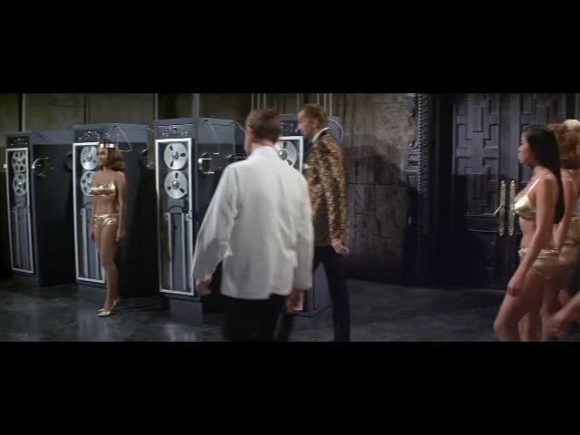 Dr Goldfoot demonstrates the programming function of his Bikini Machine 